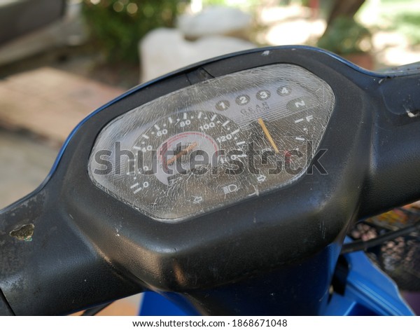 closeup of old motorcycle dashboard or\
mileage speedometer.