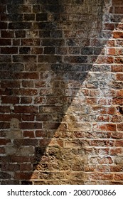 Closeup old red brick wall background with cross sun light line