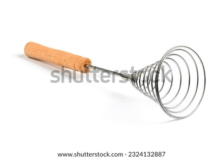 Close-up of old retro whisk kitchen tool on white background. Side view. High resolution photo. Full depth of field.