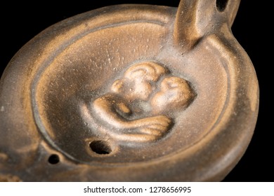 Closeup Of An Old Roman Oil Lamp, Black Background