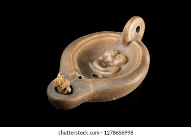 Closeup Of An Old Roman Oil Lamp, Black Background