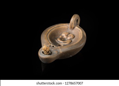 Closeup Of An Old Roman Oil Lamp, Black Background