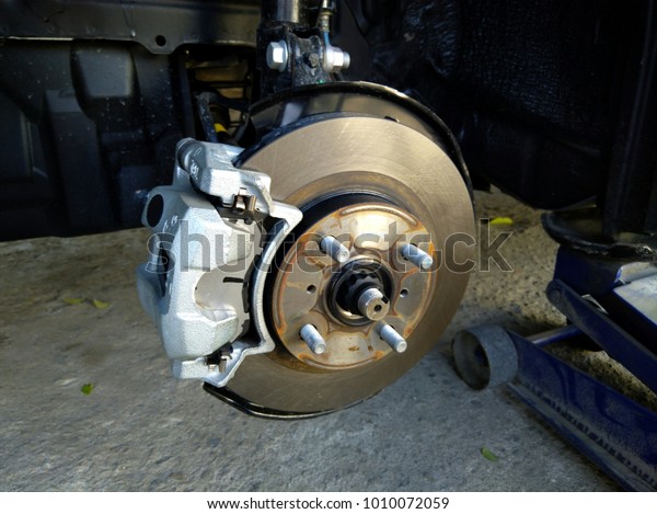 Close-up old and rusted brake discs With caliper\
parts of cars that receive service and repair, change new brake\
pads in auto repair\
centers.