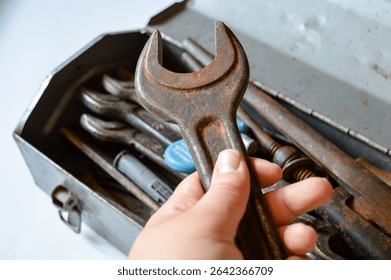 Close-up old rusty hand tools in metal toolbox. Emphasizes textures and patina on vintage wrenches hardwar industrial design Backgrounds mechanical restoration refurbishing garage workshops repair
