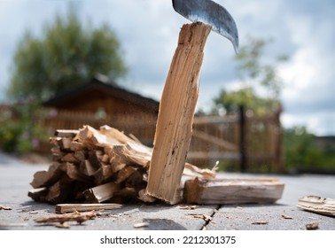 Close-up Of An Old, Rusty Knife Chopping Wood For Lighting The Fireplace