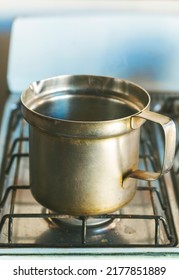 Closeup Of Old Saucepan On Gas Cooker