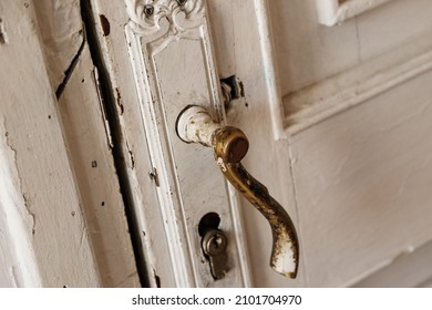 Closeup Of Old Shabby Door Handle On The White Door