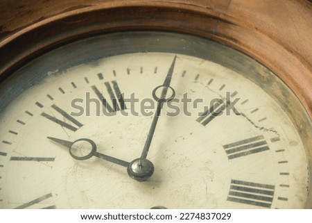Close-up of an old shabby retro clock, the time is almost midnight. Concept of time, past or deadline.