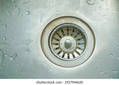 Closeup Of Old Stainless Kitchen Sink With Drops Of Water.