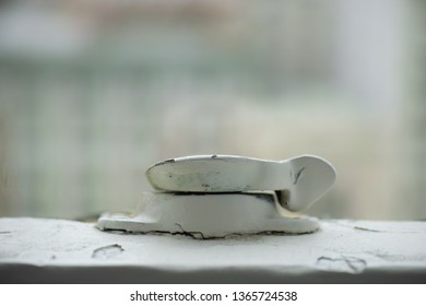 Close-up of an old window latch.
