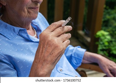 Close-up Of Old Woman Smoking A Cigarette