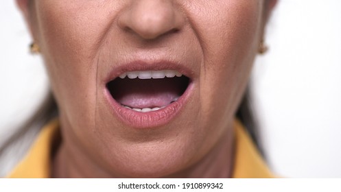 Close-up Old Woman Yelling. Close-up Old Womans Mouth And Lips. White Background.