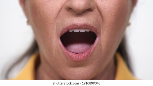 Close-up Old Woman Yelling. Close-up Old Womans Mouth And Lips. White Background.