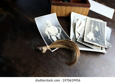 Closeup Old Wooden Box, A Stack Of Retro Photos, A Lock Of Hair, Vintage Photographs Of 1960, Concept Of Family Tree, Genealogy, Childhood Memories