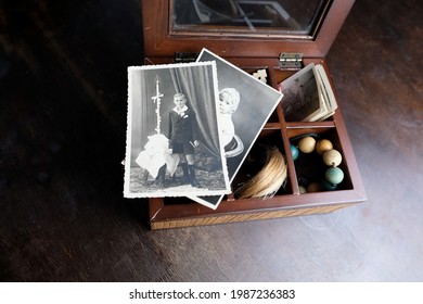 Closeup Old Wooden Box, A Stack Of Retro Photos, A Lock Of Hair, Vintage Photographs Of 1960, Concept Of Family Tree, Genealogy, Childhood Memories