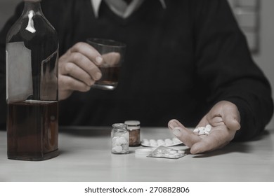Close-up of older man sipping his drugs with alcohol