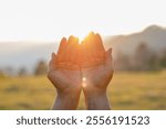 Closeup older woman hands placed together like praying worship at sunset.worship god with christian concept religion.