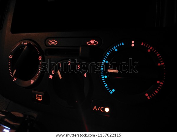 Closeup on Air conditioner controller on dashboard\
panel car