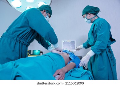 Close-Up On Asian Surgical Team Performing CPR On Heart Attack Patient In Hospital Operating Room