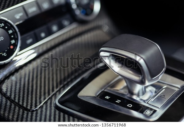Close-up on\
automatic transmission lever in modern\
car