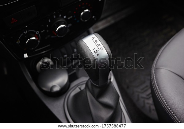 Close-up on automatic\
transmission lever in modern car. Car interior details.\
Transmission shift.