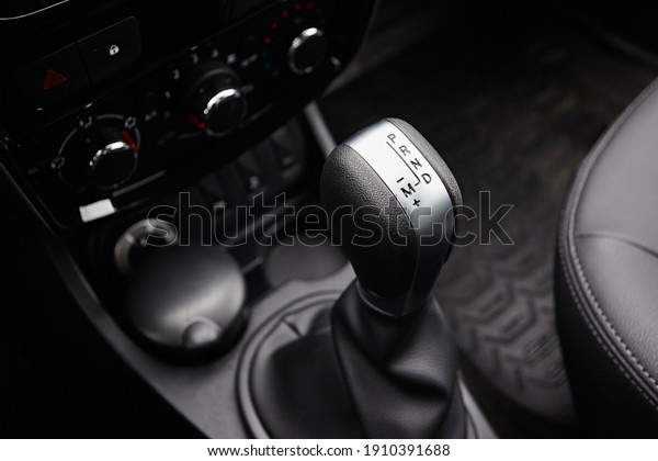 Close-up on automatic\
transmission lever in modern car. Car interior details.\
Transmission shift.