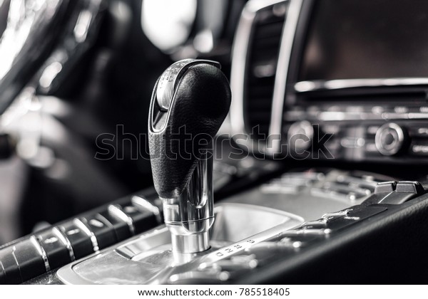 Close-up on automatic transmission lever in modern\
car. multimedia and navigation control buttons. Car interior\
details. Transmission\
shift.