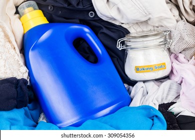 Closeup On Baking Soda With Detergent And Pile Of Dirty Laundry