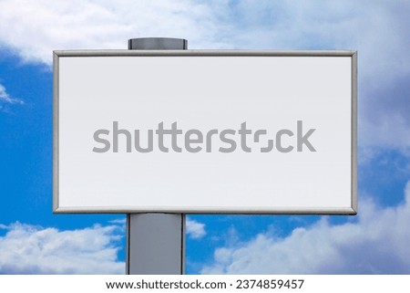Close-up on a blank billboard against a cloudy sky.