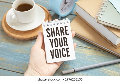 Closeup On Businessman Holding A Card With Text SHARE YOUR VOICE, Business Concept Image With Soft Focus Background And Vintage Tone