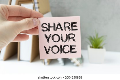 Closeup On Businessman Holding A Card With Text SHARE YOUR VOICE, Business Concept Image With Soft Focus Background And Vintage Tone