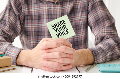 Closeup On Businessman Holding A Card With Text SHARE YOUR VOICE, Business Concept Image With Soft Focus Background And Vintage Tone