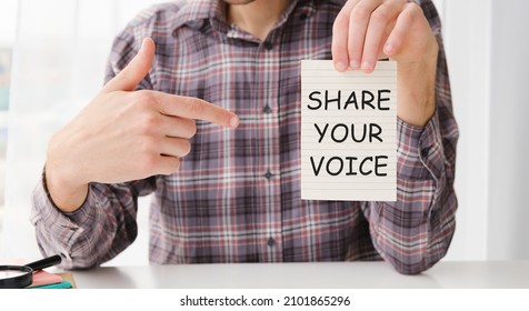 Closeup On Businessman Holding A Card With Text SHARE YOUR VOICE, Business Concept Image With Soft Focus Background And Vintage Tone