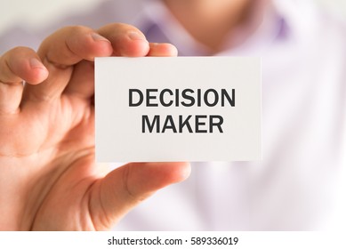 Closeup On Businessman Holding A Card With DECISION MAKER Message, Business Concept Image With Soft Focus Background And Vintage Tone