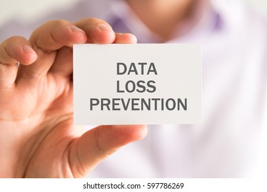 Closeup On Businessman Holding A Card With DLP Data Loss Prevention Message, Business Concept Image With Soft Focus Background