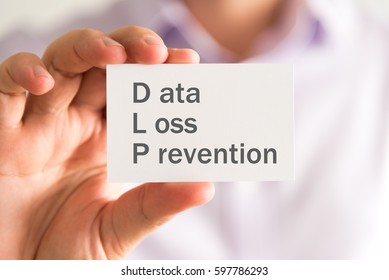 Closeup On Businessman Holding A Card With DLP Data Loss Prevention Message, Business Concept Image With Soft Focus Background