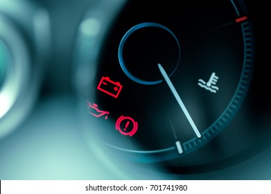 close-up on car dashboard and warning icon 