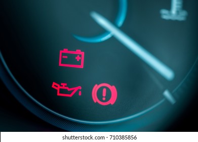 Close-up on car dashboard and warning icon