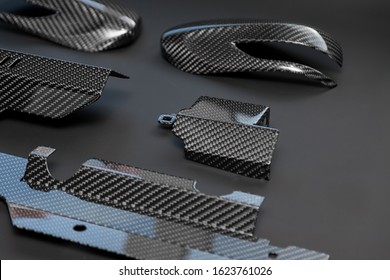 A Close-up On A Car Exterior Elements Made From Carbon Fiber Of Interwoven Black And Gray Color From Heavy-duty Yarns For The Production Of Light And Durable Elements In Industry. Tuning Body Parts.