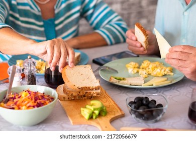 Closeup on caucasian senior couple sitting at the table having brunch at home - Powered by Shutterstock