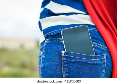 Closeup On Cell Phone In Back Pocket Of Female Jeans