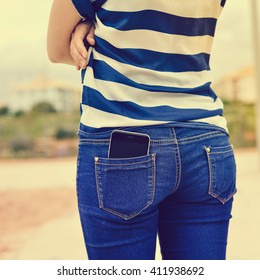 Closeup On Cell Phone In Back Pocket Of Female Jeans