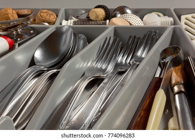 Close-up On On The Contents Of A Kitchen Drawer Full Of Cutlery And Utensils