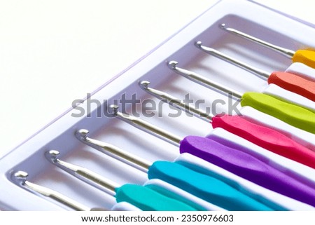 Close-up on crochet hooks set in different sizes with multicoloured handles