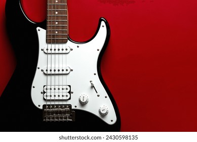 Close-up on electric guitar with space for text over red background - Powered by Shutterstock