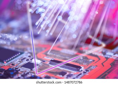 Closeup on electronic board and neon electric lights, blurred and toned electronic background in pink, blue and purple
