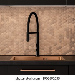 Close-up On Elegant Kitchen With Black Faucet And Copper, Hexagonal Wall Tiles And Copper Sink