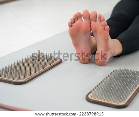 Close-up on the feet of a woman after standing on the nails of a sadhu.