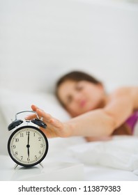 Closeup On Female Hand Reaching To Turn Off Alarm Clock