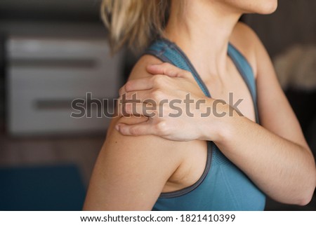 Closeup on fitness woman having pain in shoulder. Pain after home workout